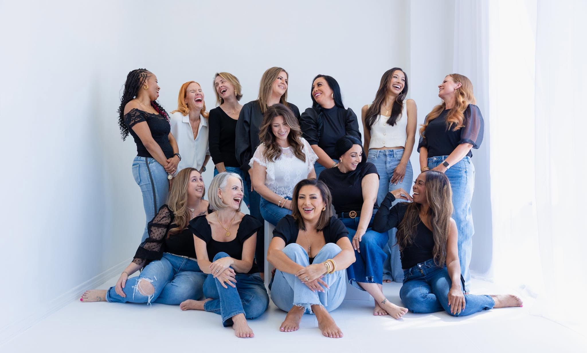 EmpowerHERLife team members laugh at a photoshoot celebrating women in business